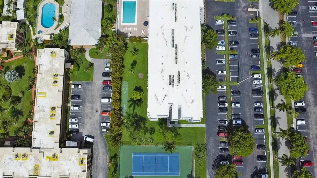1301 Northeast 7th Street, Unit 113 Hallandale Beach, FL 33009 - Photo 39 of 45 an aerial view of residential house with outdoor space and parking