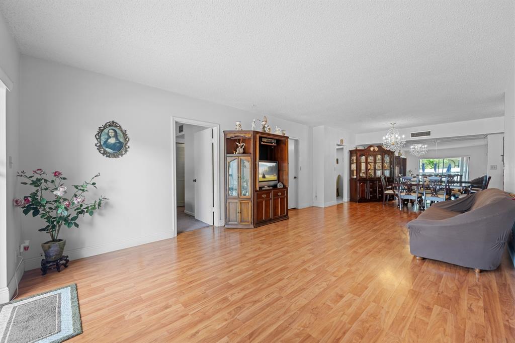 1301 Northeast 7th Street, Unit 113 Hallandale Beach, FL 33009 - Photo 7 of 45 a living room with furniture and a wooden floor