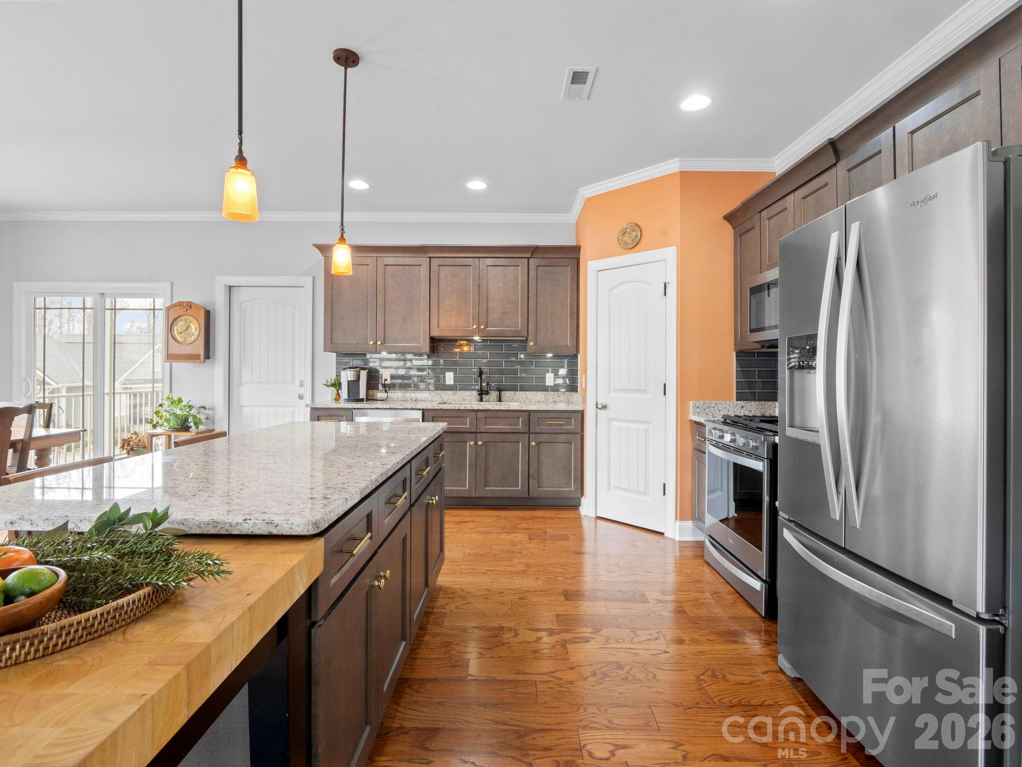 614 Downing Way Landrum, SC 29356 - Photo 12 of 46 a kitchen with stainless steel appliances granite countertop sink refrigerator and microwave