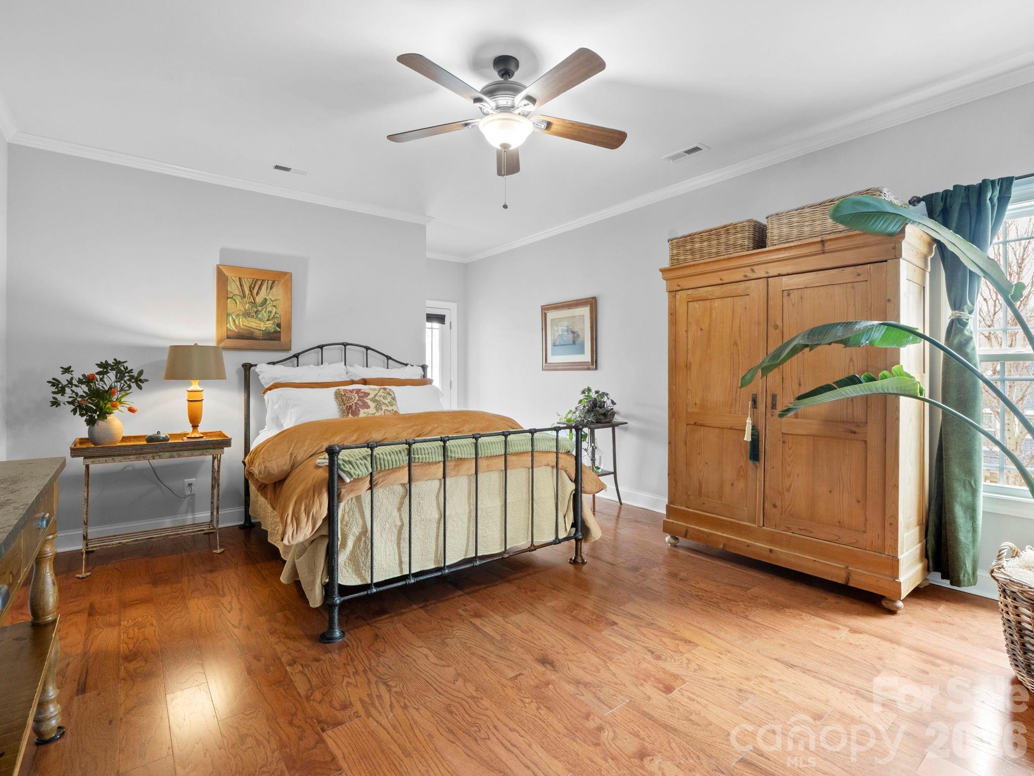 614 Downing Way Landrum, SC 29356 - Photo 19 of 46 a bedroom with a bed and a chandelier