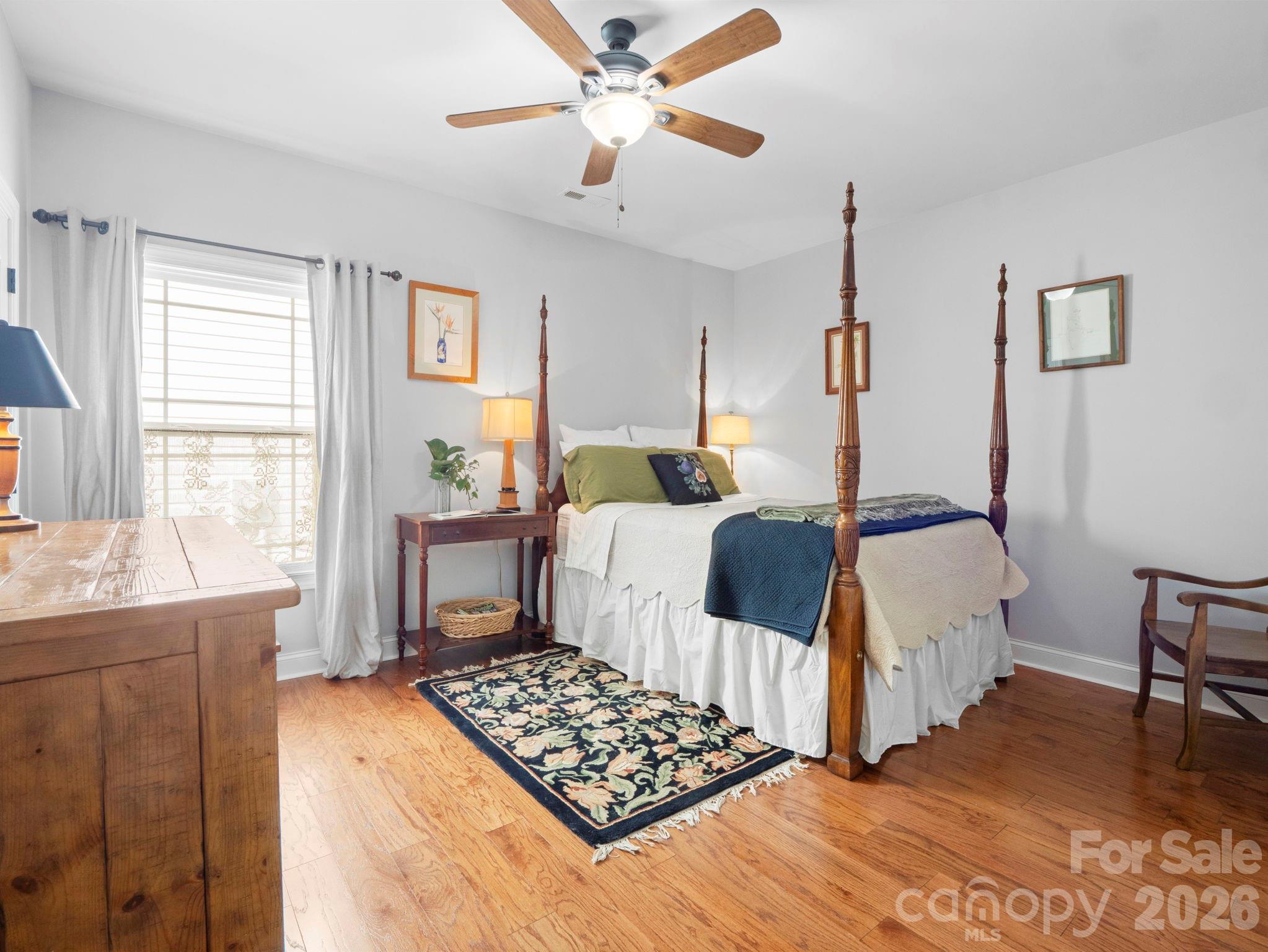 614 Downing Way Landrum, SC 29356 - Photo 29 of 46 a bedroom with a bed and a table with stool