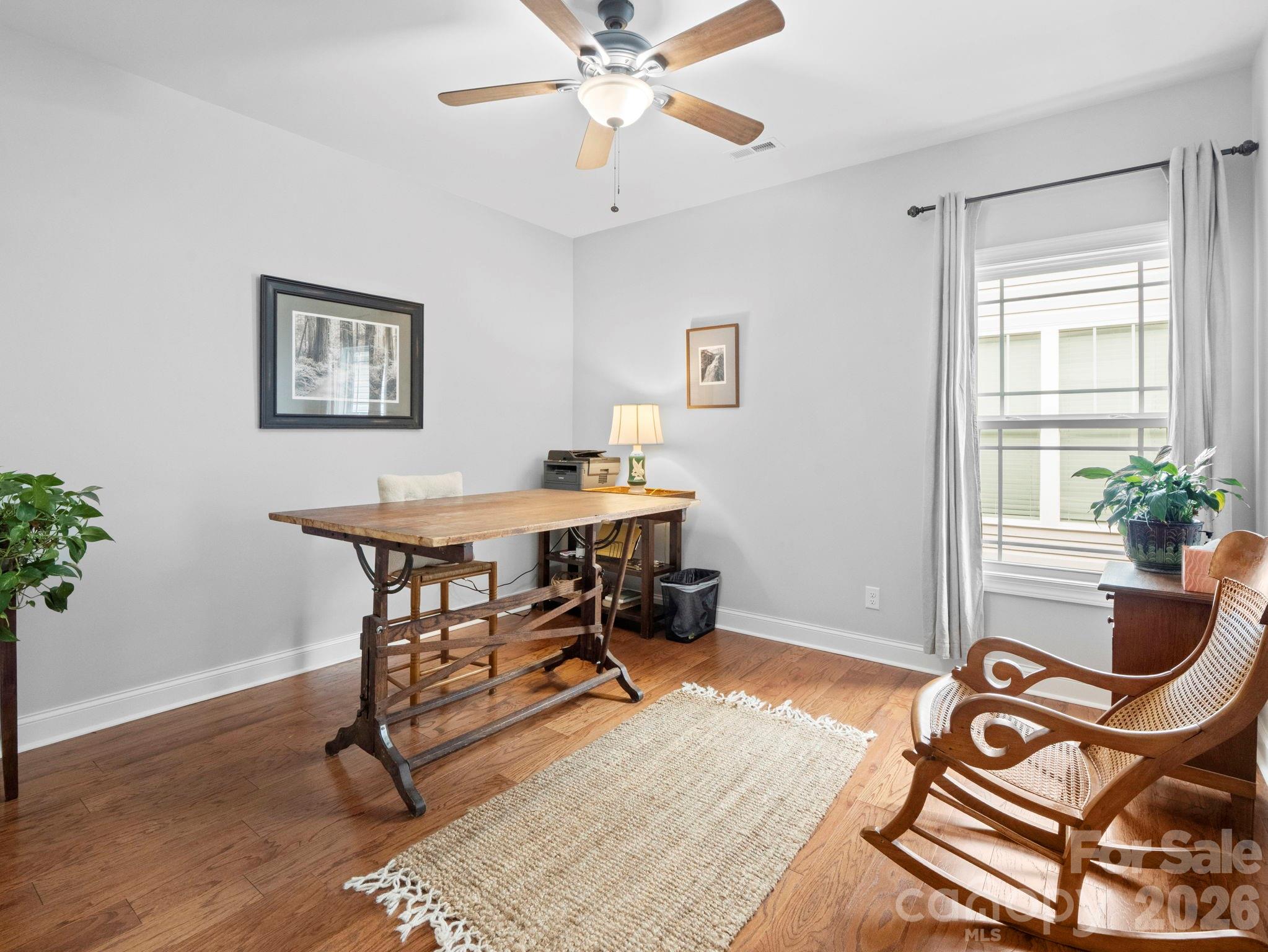 614 Downing Way Landrum, SC 29356 - Photo 31 of 46 a workspace with wooden floor and a potted plant