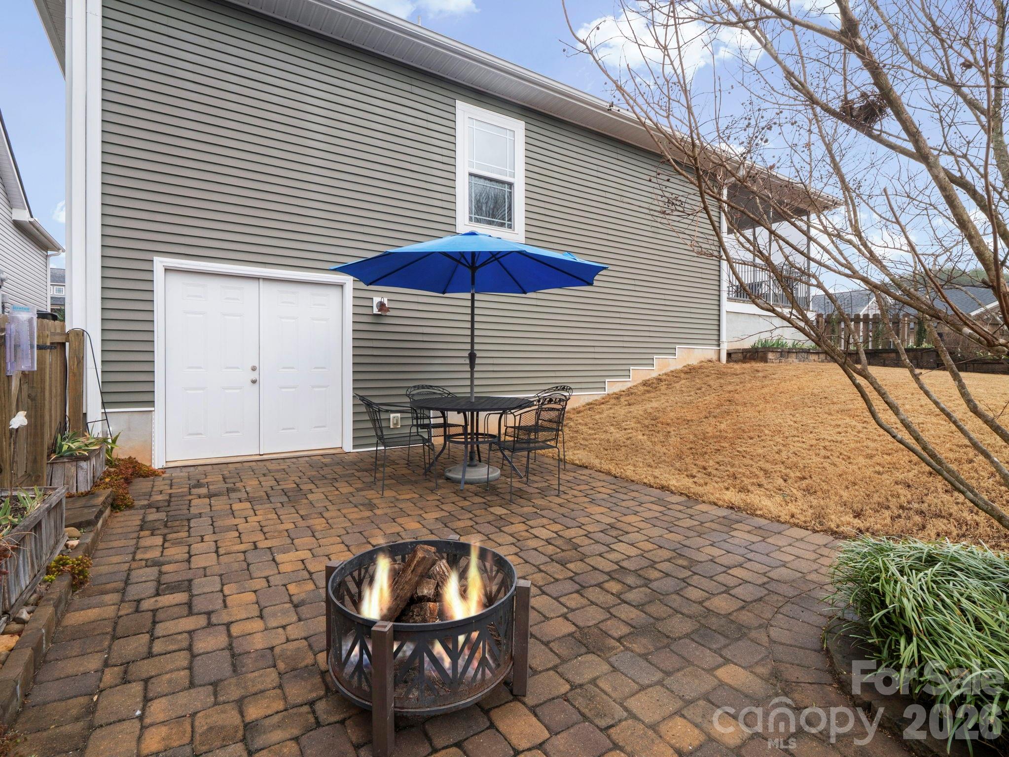 614 Downing Way Landrum, SC 29356 - Photo 40 of 46 a backyard of a house with barbeque oven table and chairs