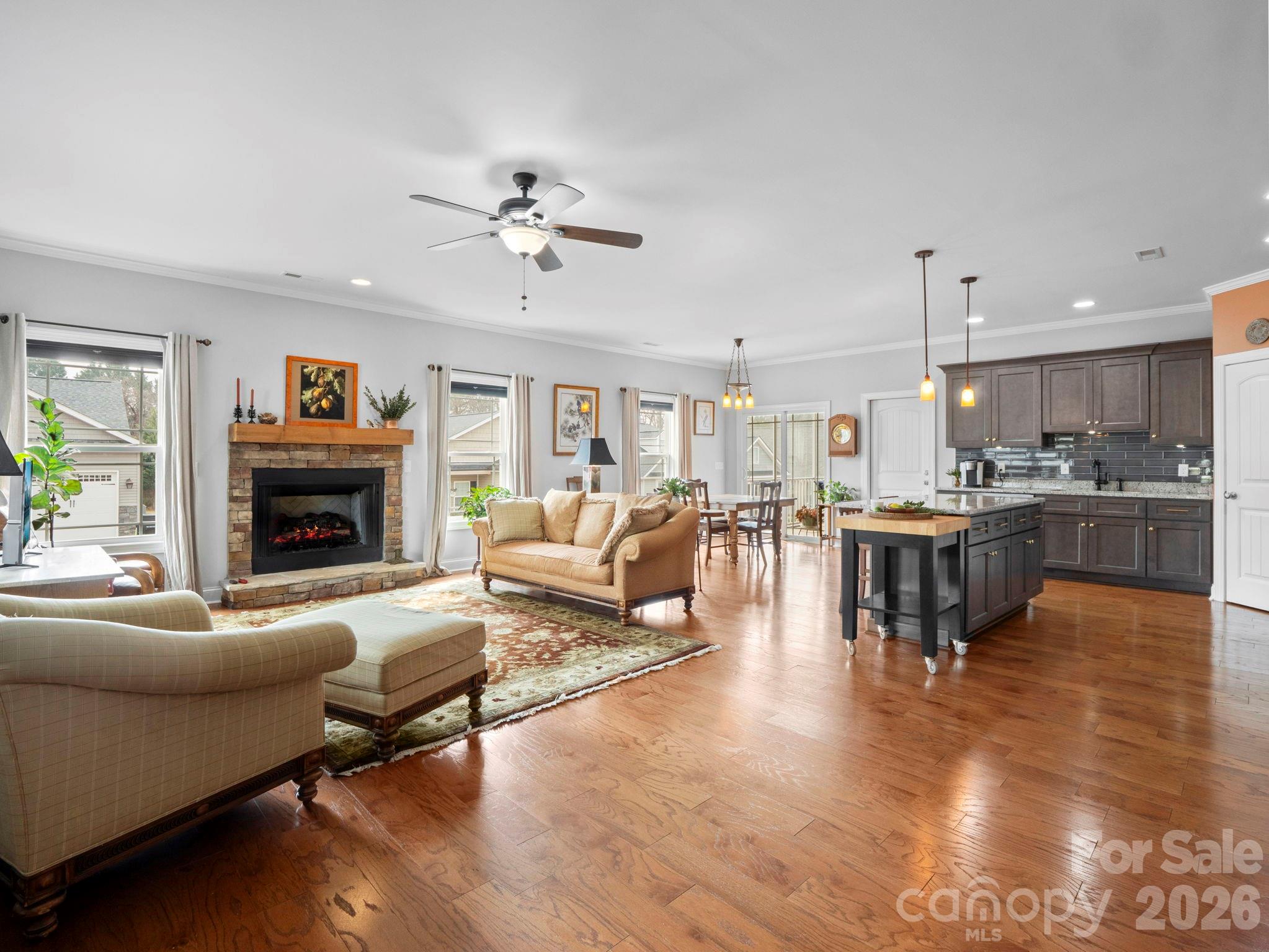 614 Downing Way Landrum, SC 29356 - Photo 7 of 46 a living room with furniture kitchen view and a fireplace