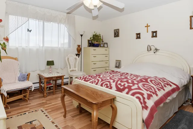 a bedroom with a bed and a chandelier