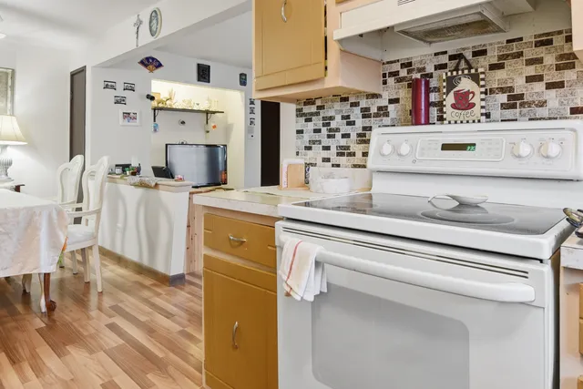 a kitchen with stainless steel appliances a stove and cabinets