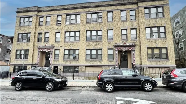 a view of a car parked in front of a building