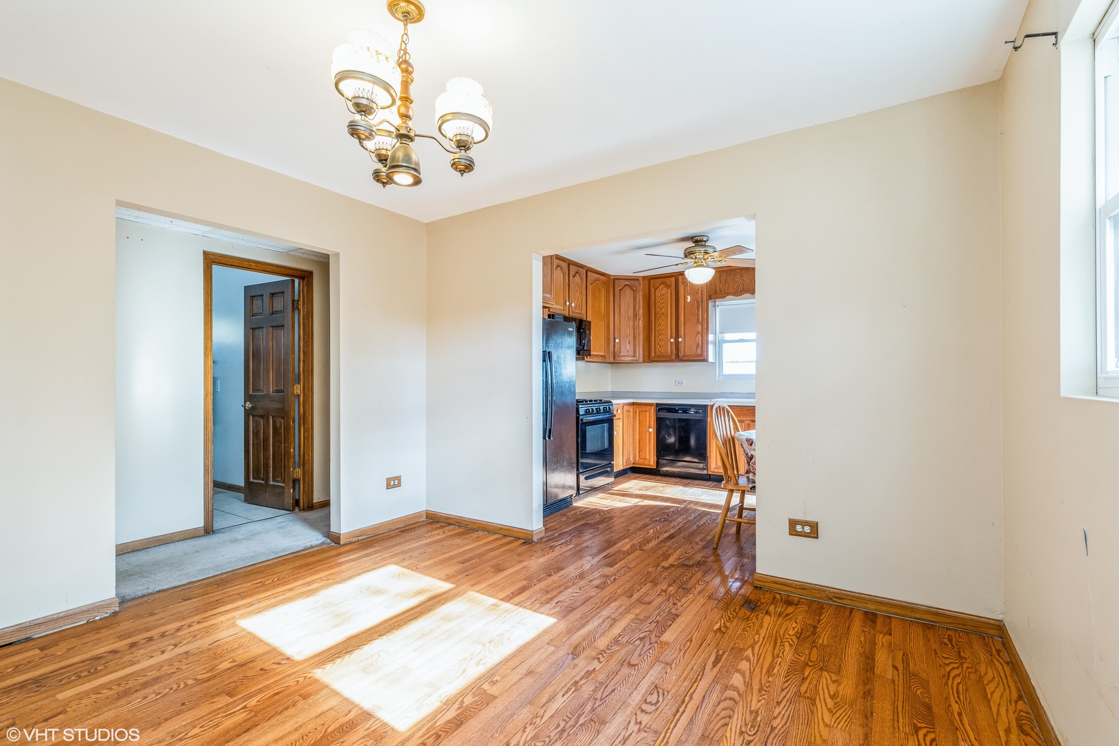 81 Tweed Road Fox Lake, IL 60020 - Photo 5 of 15 a view of a livingroom with wooden floor and a chandelier