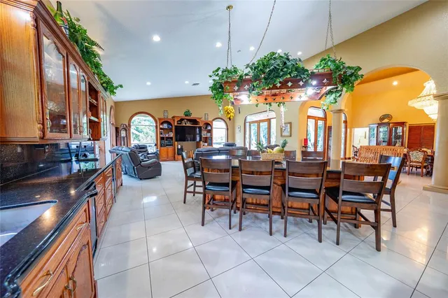 a living room with fireplace furniture and a large window