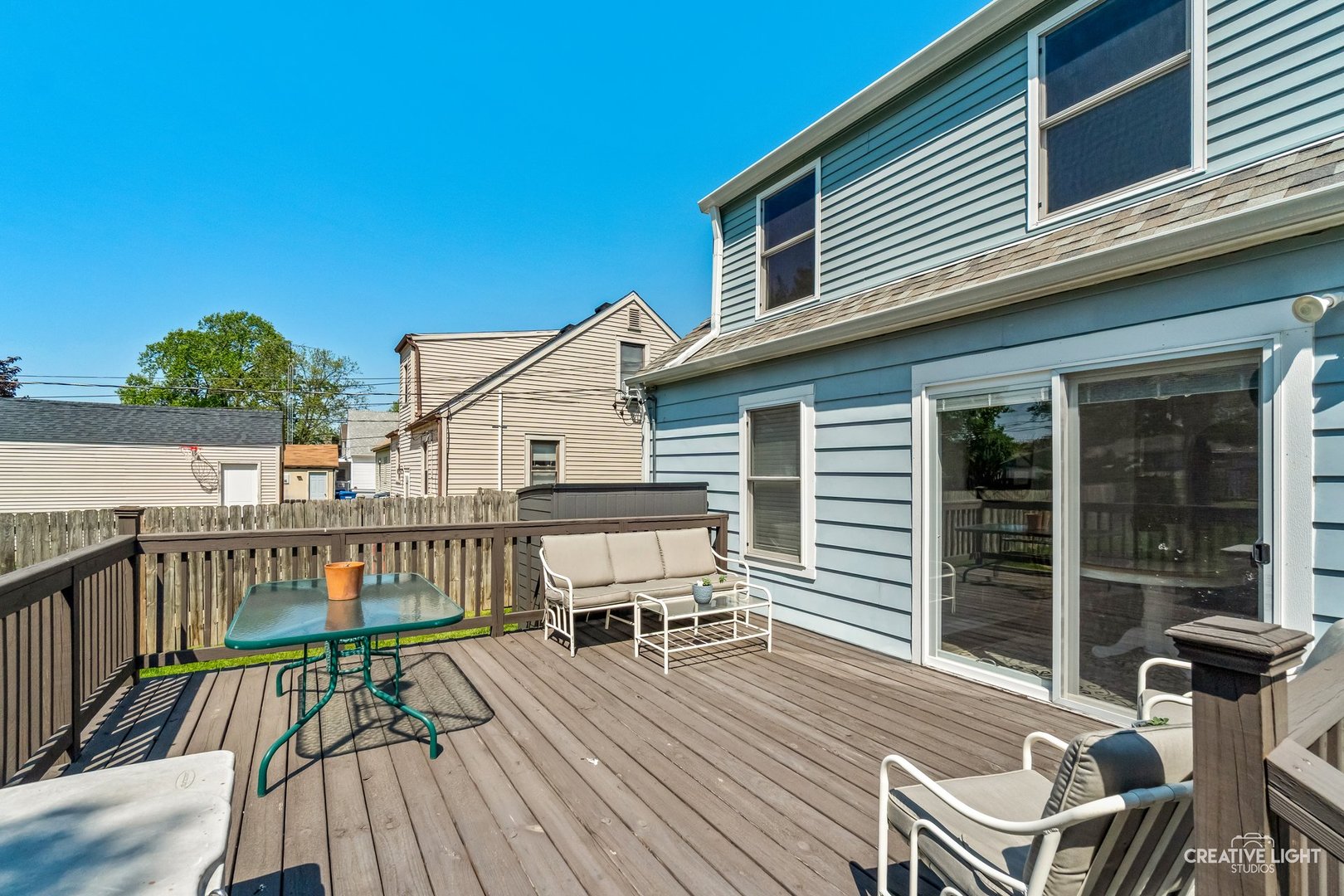 1606 Clark Street DeKalb, IL 60115 - Photo 15 of 20 a view of a house with wooden deck and furniture