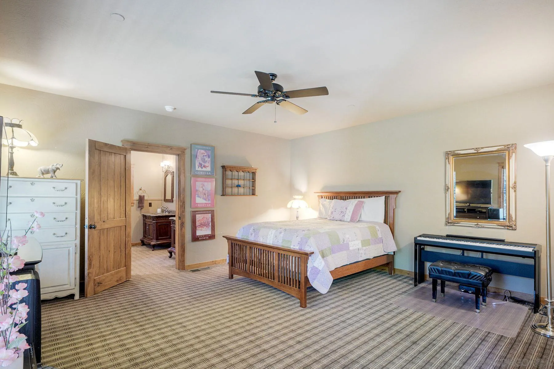 1055 West Incense Cedar Road Julian, CA 92036 - Photo 32 of 56 a bedroom with a bed and a chandelier