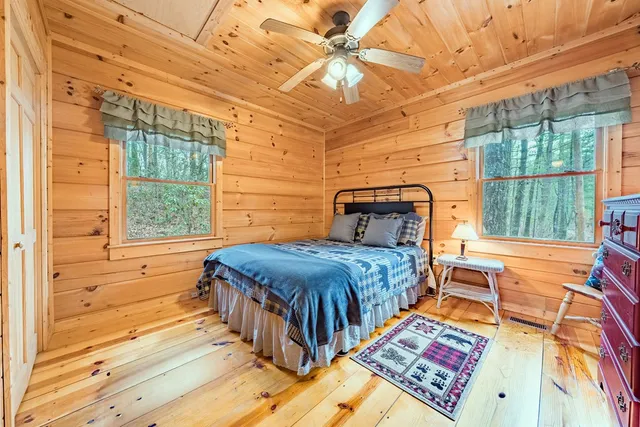 a bedroom with a bed next to a window