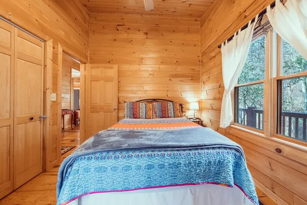 a bedroom with a large bed and a flat tv