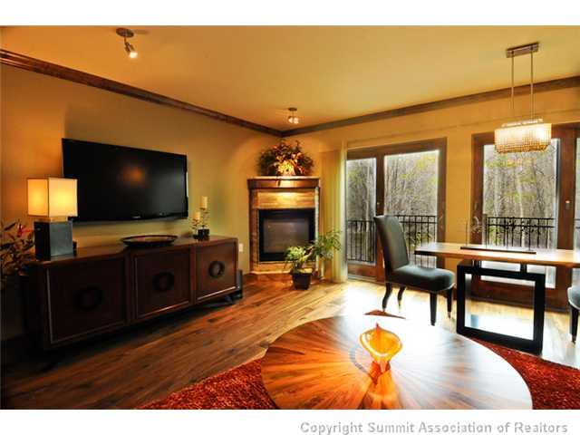 487 Main Street, Unit D Frisco, CO 80443 - Photo 2 of 25 a living room with furniture and a flat screen tv