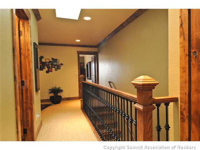487 Main Street, Unit D Frisco, CO 80443 - Photo 14 of 25 a view of a hallway with a dining area and chandelier
