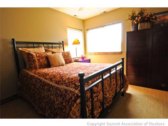 487 Main Street, Unit D Frisco, CO 80443 - Photo 16 of 25 a bedroom with a bed and wooden floor