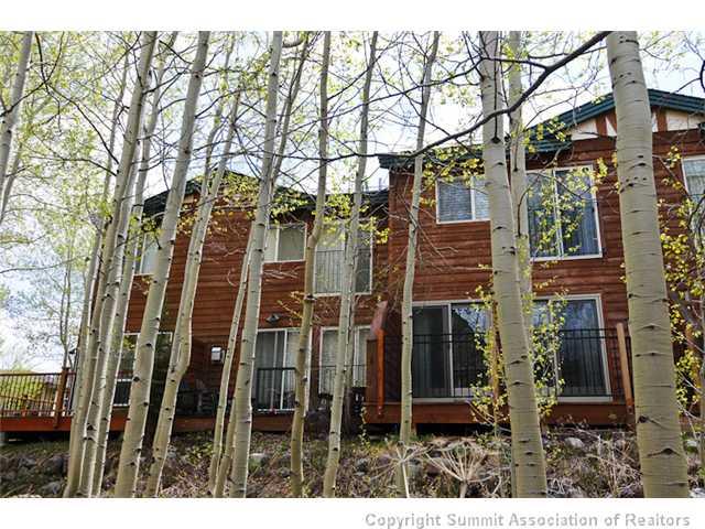 487 Main Street, Unit D Frisco, CO 80443 - Photo 23 of 25 a view of a brick house with a large windows and wooden fence