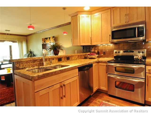 487 Main Street, Unit D Frisco, CO 80443 - Photo 6 of 25 a kitchen with a sink stove and microwave