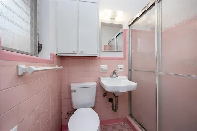 a bathroom with a sink a toilet and mirror