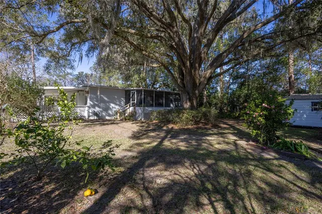 a view of swimming pool with a yard and green space