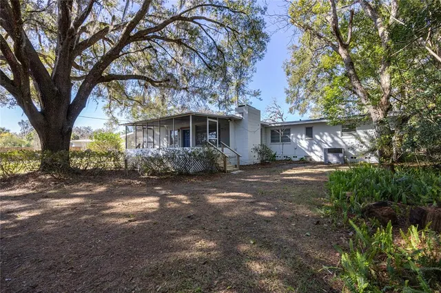 a view of a house with a tree in the yard