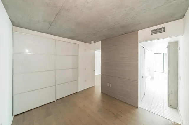 a view of walk in closet with empty racks