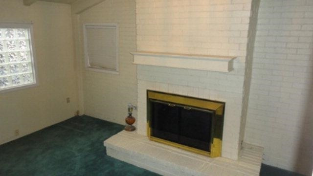 2412 36th Street Lubbock, TX 79412 - Photo 2 of 10 a living room with a fireplace in it