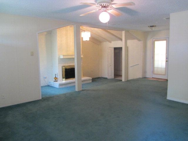 2412 36th Street Lubbock, TX 79412 - Photo 7 of 10 an empty room with windows and fireplace