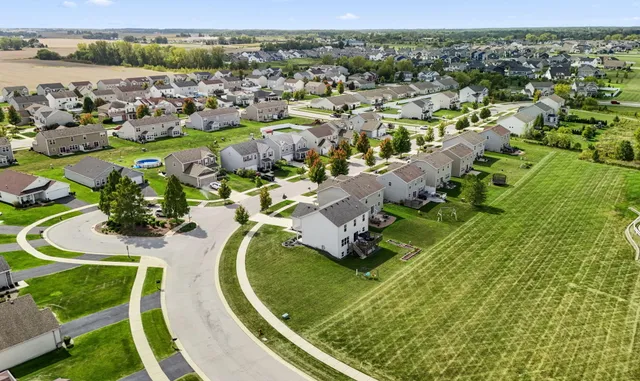 an aerial view of a house with a swimming pool yard and outdoor seating