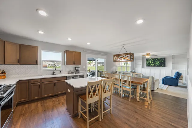 a view of a dining room with furniture and wooden floor