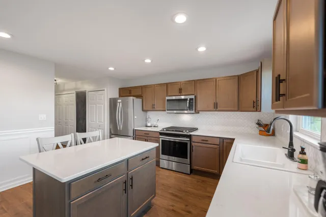 a kitchen with stainless steel appliances a sink stove and refrigerator