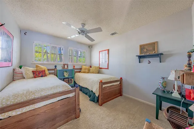 a bedroom with a bed wooden floor and window