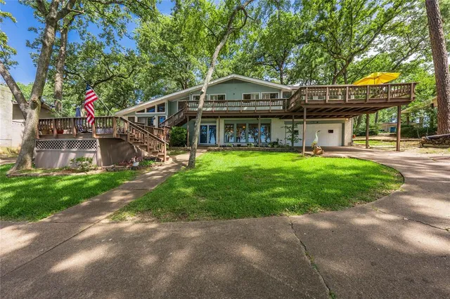 a view of a house with a yard and sitting area