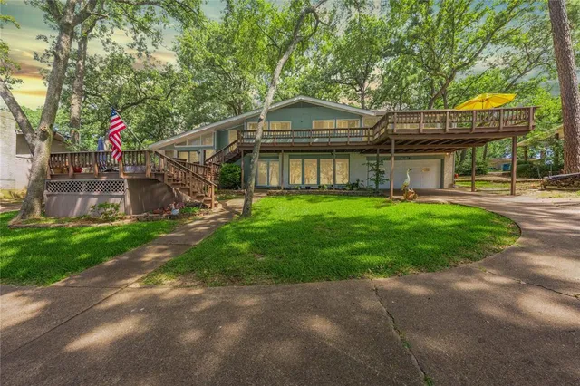 a view of a house with a yard and sitting area