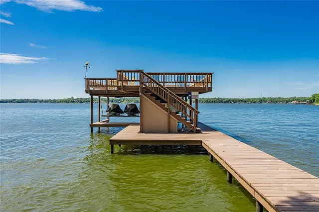 a view of a lake with couches chairs