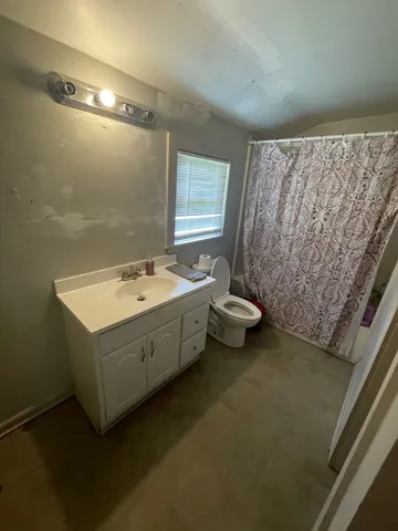 a bathroom with a sink toilet and tub
