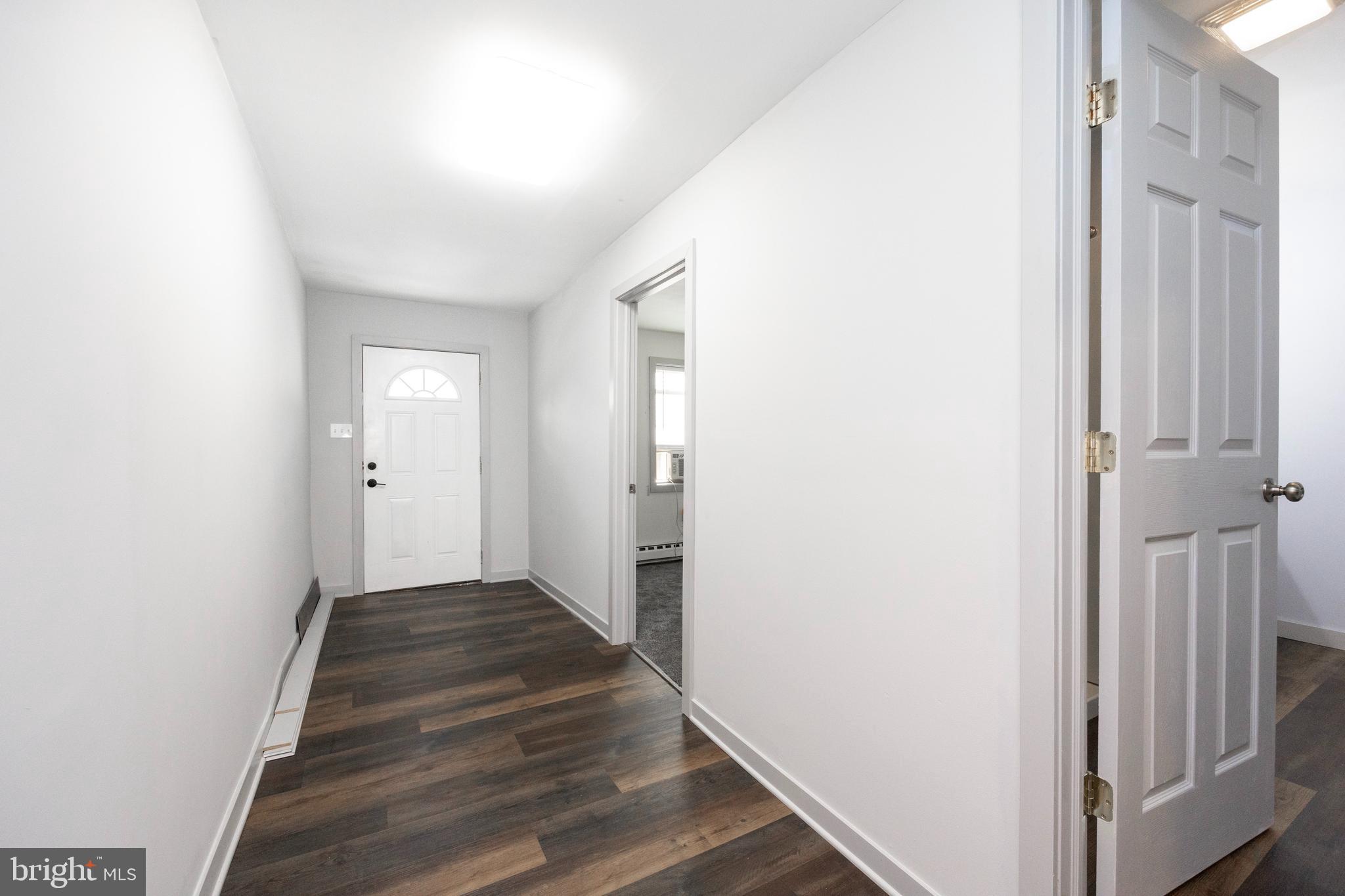 58 East 4th Street, Unit 2 Bridgeport, PA 19405 - Photo 14 of 28 a view of a hallway with wooden floor and entryway