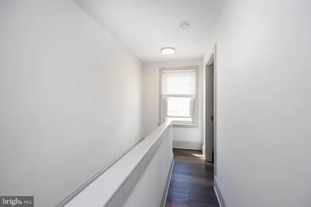 a view of hallway with wooden floor