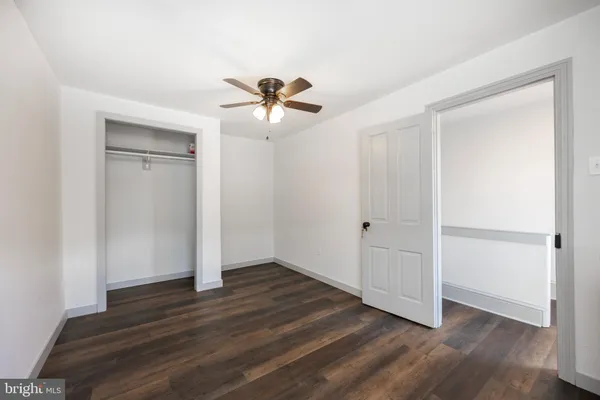a view of room with hardwood floor and ceiling fan