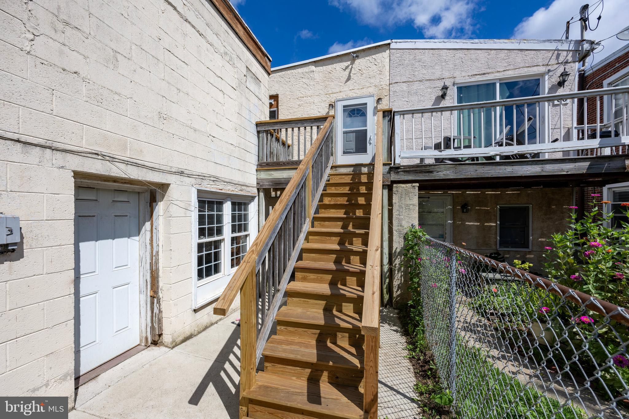 58 East 4th Street, Unit 2 Bridgeport, PA 19405 - Photo 24 of 28 a front view of a house with wooden stairs and a potted plant