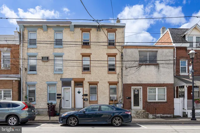 a front view of a house with parking space