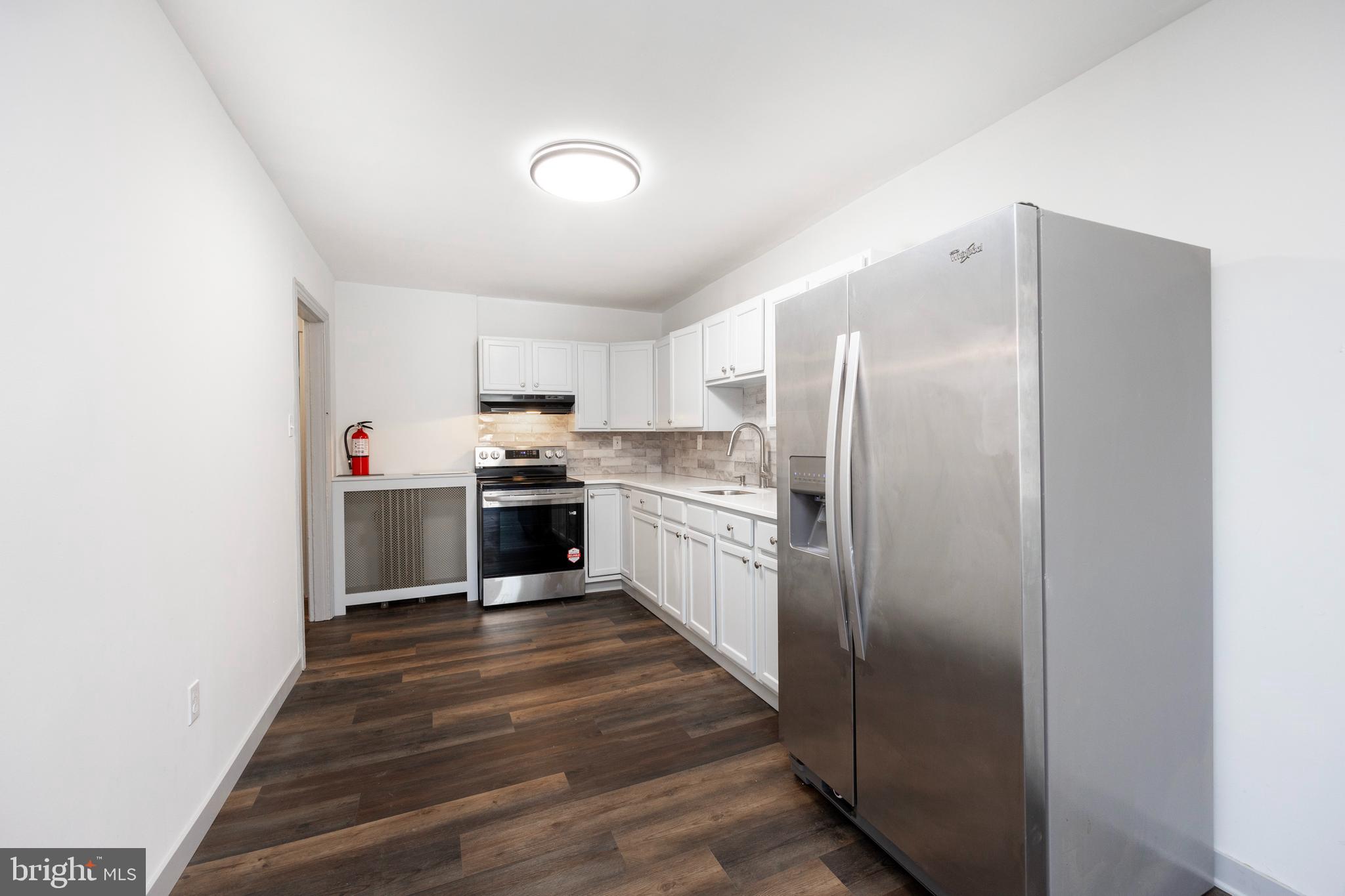 58 East 4th Street, Unit 2 Bridgeport, PA 19405 - Photo 3 of 28 a kitchen with stainless steel appliances a refrigerator and a stove top oven