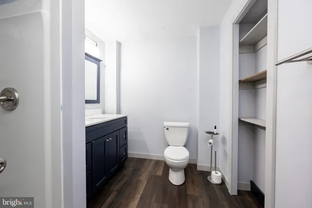 a bathroom with a toilet sink and mirror