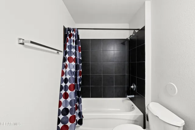 a bathroom with a bathtub and shower