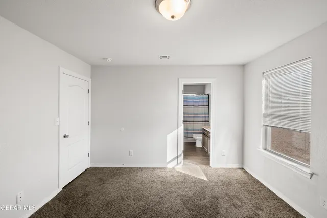 a view of an empty room with a closet