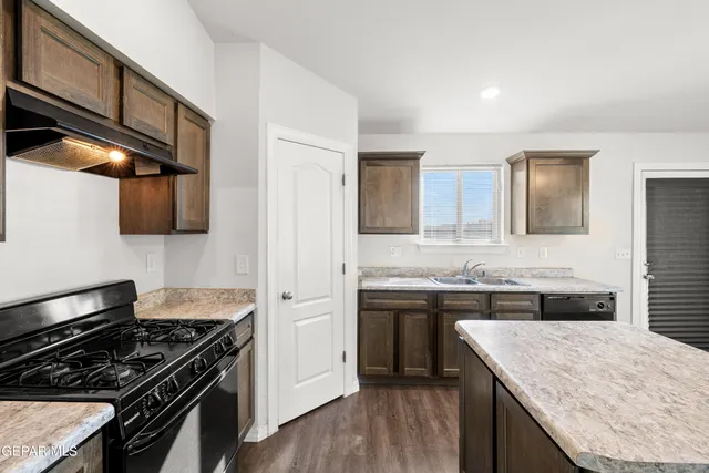 a kitchen with a stove and a sink