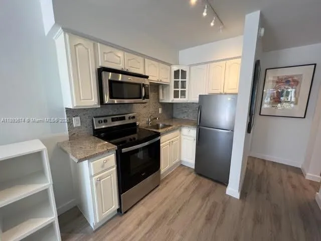 a kitchen with a refrigerator stove and microwave