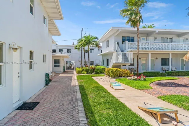 a front view of a house with a yard table and chairs