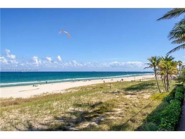 a building outdoor space with patio furniture and a fireplace