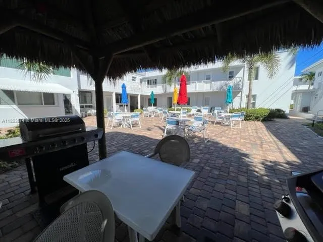 a view of a backyard with sitting area